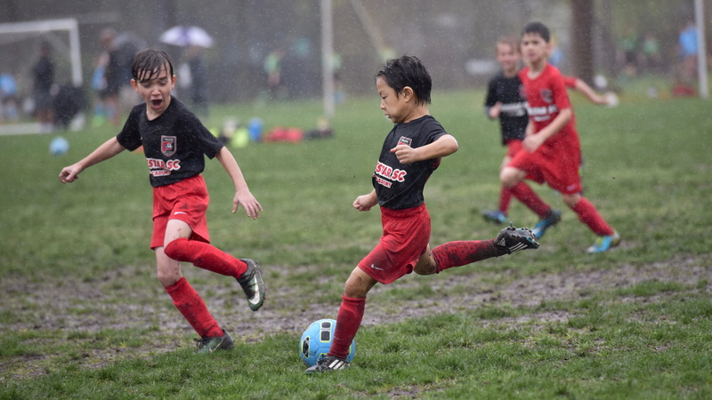 playing, full length, childhood, sports clothing, people, sport, togetherness, grass, effort, soccer, nature, clothing, rain, united states, vitality, boys