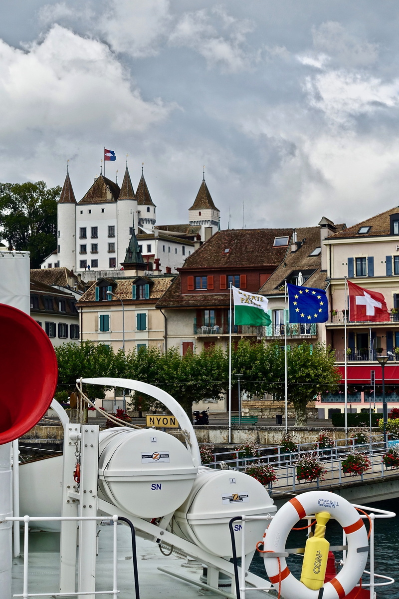nautical vessel, river, nature, outdoors, building, castle, city, sightseeing, landmark, street, building exterior, red, mode of transportation, transportation