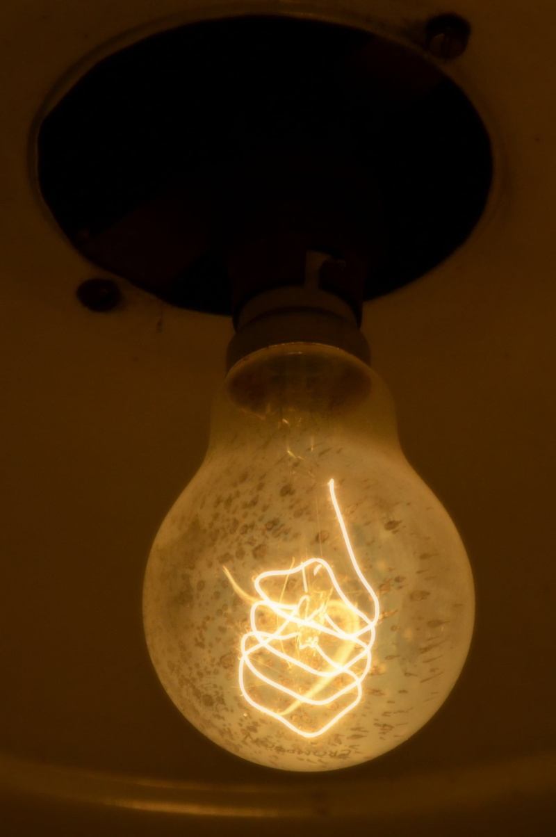 illuminated, bulb, light - natural phenomenon, single object, nostalgia, technology, close-up, lamp, filament, glowing, dark, edison, low angle view, disappearing
