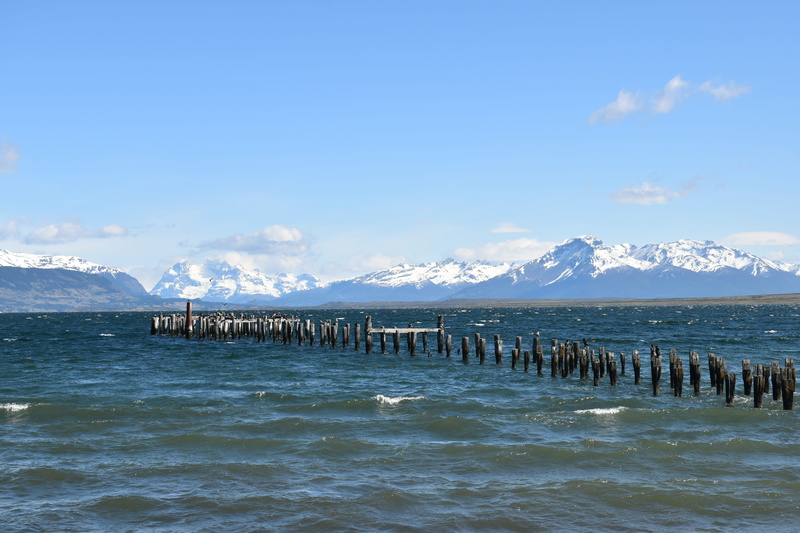 tranquil scene, mountains, beauty in nature, no people, day, blue, snowcapped mountain, sea bridge, wooden post, non-urban scene, cloud - sky, tranquility