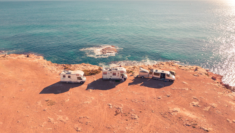 no people, high angle view, outdoors, transportation, rv, home, rock - object, sea, day, near, white, three, land, beauty in nature, tranquility, travel