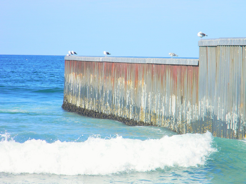 horizon, clear sky, playas de tijuana, waterfront, outdoors, built structure, wave, border, beauty in nature, day, nature, blue, sea, sport, sky, motion