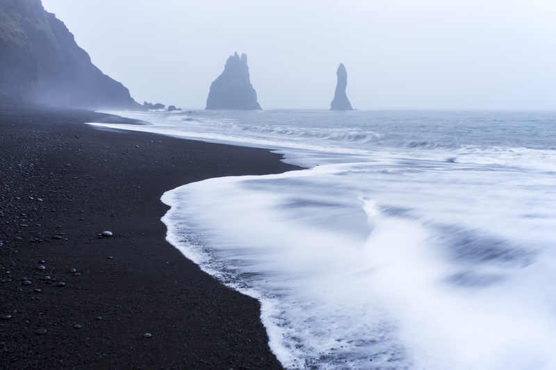land, shore, tranquility, nature, stack rock, beach, horizon, idyllic, water, beauty in nature, black sand, rock - object, house, horizon over water, day