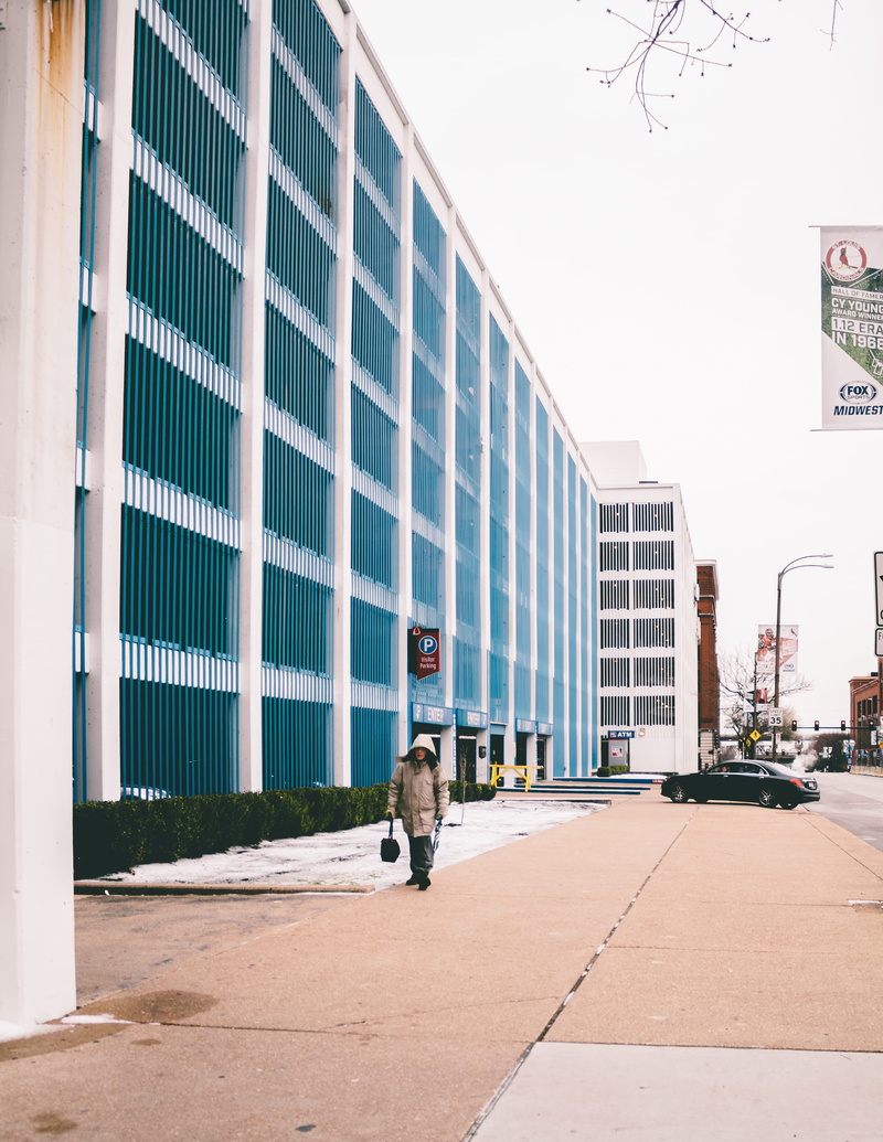 street photography, cars, footpath, city, clouds, building exterior, mammal, go, united states, st louis, parking garage, day, motor vehicle, office building exterior