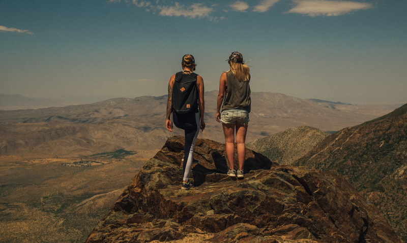 mountain range, beauty in nature, grand, rock - object, two, exploration, standing, rock, couple - relationship, scenics - nature, full length, backpack