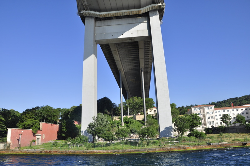 building exterior, river, connection, blue, sunlight, water, bridge, transportation, plant, bosphorus bridge, architectural column, tree, clear sky, waterfront