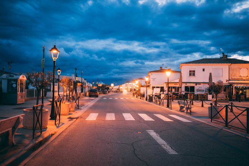 diminishing perspective, cloud - sky, saintes-maries-de-la-mer, street light, street, sign, blue hour, dusk, lights, road, architecture, building, built structure