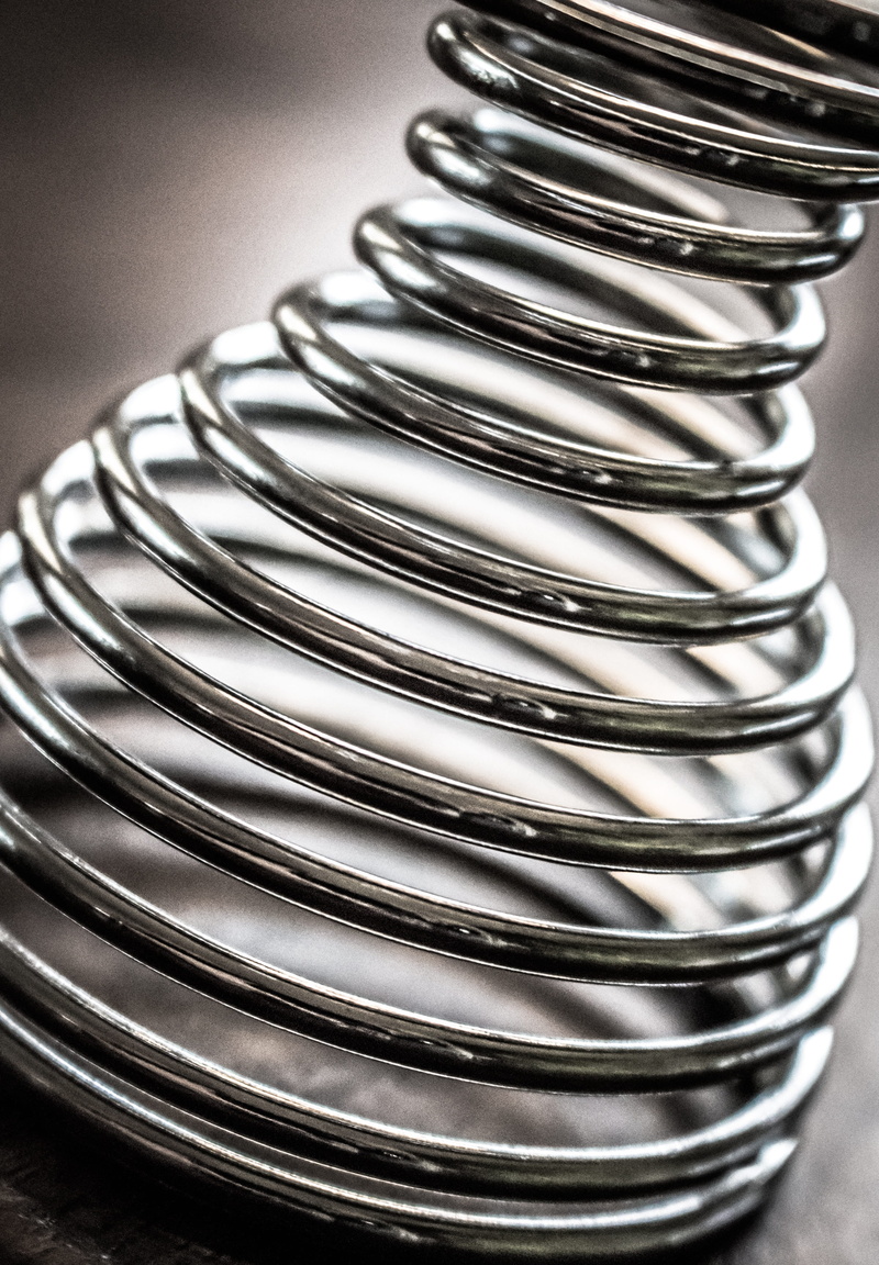 egg cups, shiny, stack, still life, pattern, silver colored, focus on foreground, table, design, steel, close-up, repetition, eddy, coiled spring, metal