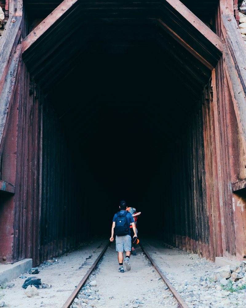 walking, men, rear view, tunnel, train track, dark, jacumba hot springs, leisure activity, 2K, women, real people, lifestyles, outdoors, winter, young adult