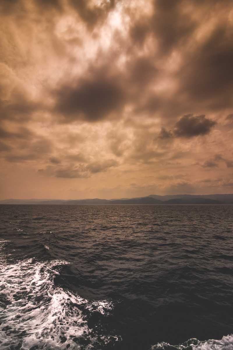 dramatic sky, wave, idyllic, sun, mountain, horizon, storm, water, cloudy, cloud, beauty in nature, sky, ocean, motion, brown, overcast, orange, ominous
