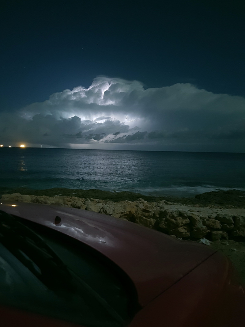 motor vehicle, nature, sky, power in nature, water, stormy, mode of transportation, beauty in nature, car, outdoors, storm cloud, thunderstorm, night, land