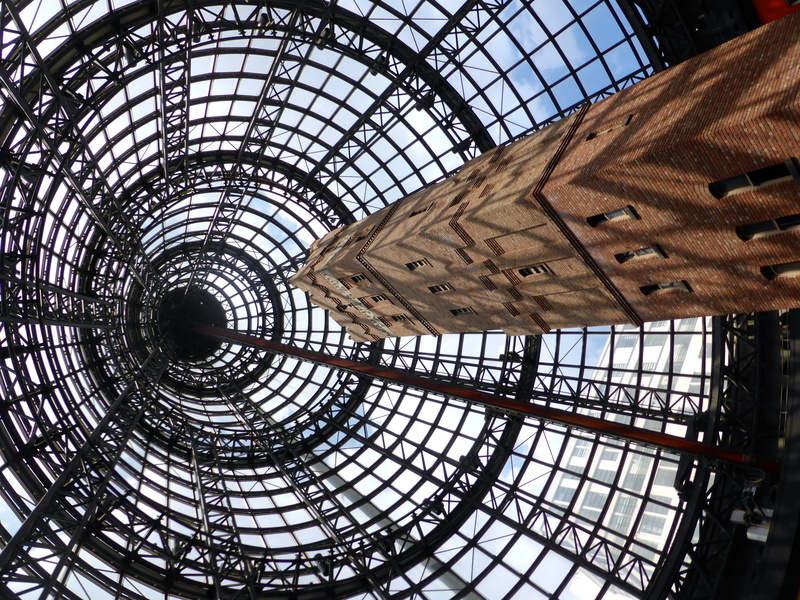low angle view, architecture, ceiling, glass, uplifting, directly below, sky, sunlight, staircase, reaching, railing, skylight, tower, no people, metal
