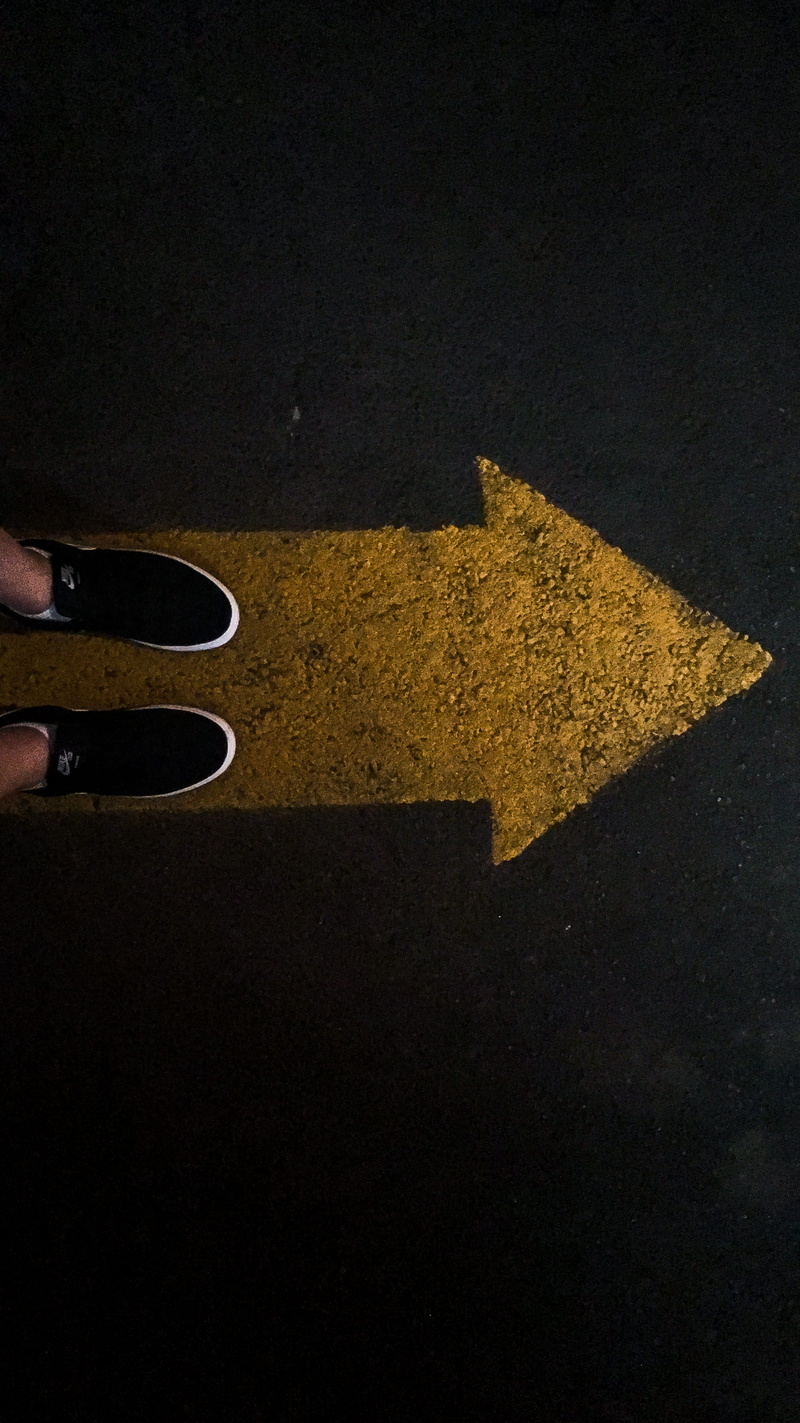 body part, yellow, real people, asphalt, sign, symbol, low section, human limb, union, black, human foot, street, road, shoes, human body part, arrow symbol