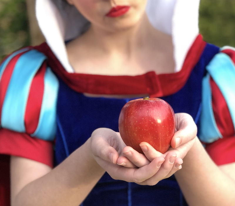 fairytale, front view, outdoors, casual clothing, day, princess, human hand, food, fruit, holding, focus on foreground, lifestyles, women, snow white, apple - fruit