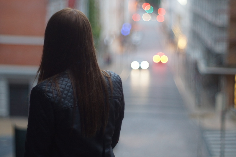focus on foreground, sony, city, one person, architecture, warm clothing, rear view, built structure, minolta, street, illuminated, a77, women, city life
