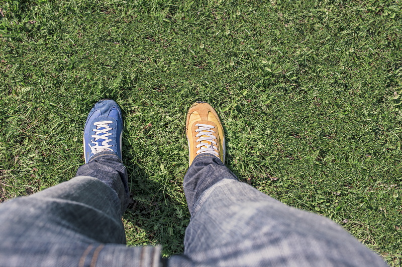 human foot, low section, lifestyles, high angle view, casual clothing, day, person, green, feet, jeans, human leg, standing, change, body part, legs, shoe