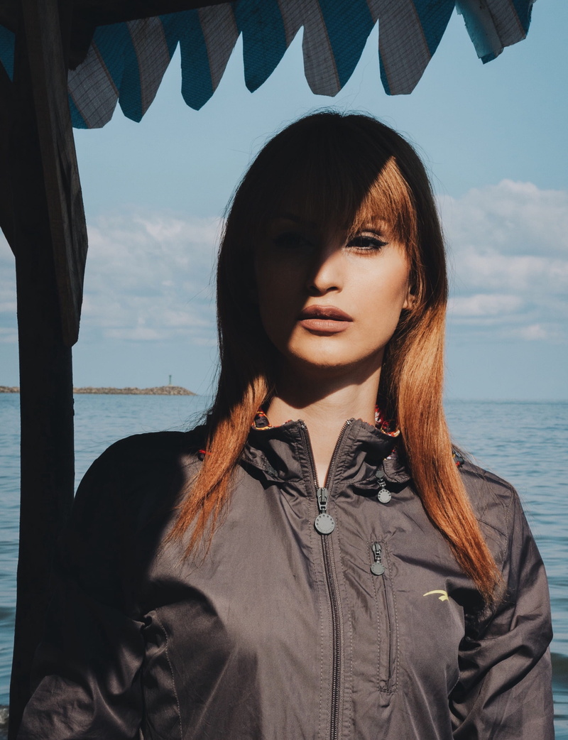 shadow, leisure activity, long sleeve, ocean, looking away, horizon over water, lifestyles, jacket, one person, cloudy, people, water, front view, dock