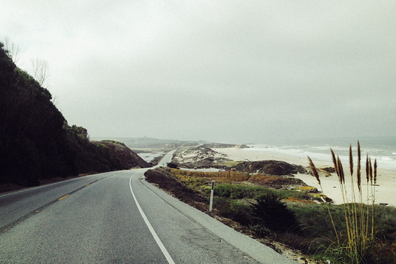 tranquil scene, near, coastal, mountain, cloud - sky, direction, sky, sign, route, open road, adventure, plant, transportation, road trip, explore, beauty in nature