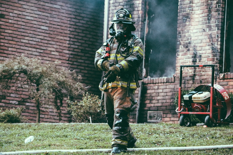 man, building, soot, real people, adjusting, helmet, architecture, garden, window, standing, firefighter, mask, tree, ash, outdoors, 5K, uniform, one person