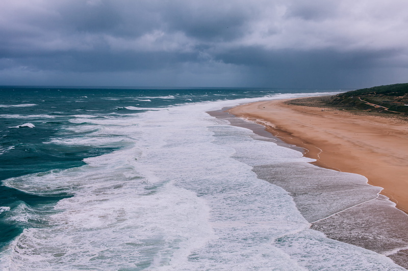 vacation, seascape, horizon over water, tranquility, aquatic sport, blue, motion, sand, land, overcast, beach, nazaré, cloudy, sky, horizon, surfing, cloud