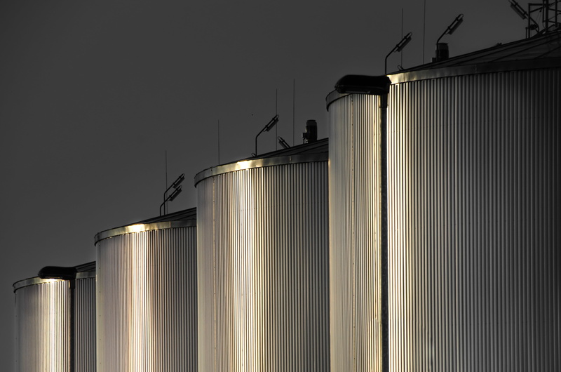 business, production, low angle view, lighting equipment, manufacturing, building exterior, storage tank, storage compartment, refinery, construction, power