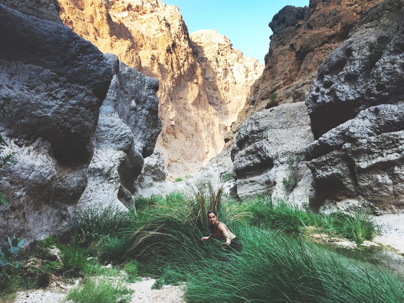 scenics - nature, solid, one person, rock - object, water, lifestyles, mountain range, 2K, oman, mountain, rock formation, formation, nature, beauty in nature