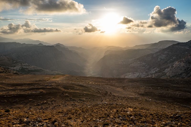 travel destinations, cloud - sky, sun, jordan, land, sunlight, mountain, mountain range, beauty in nature, environment, no people, tranquil scene, wadi dana