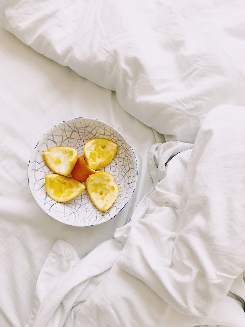 food and drink, food, indoors, plant, bedroom, directly above, meal, white color, sheet, tablecloth, lemonade, linen, citrus fruit, strawberry, grapefruit