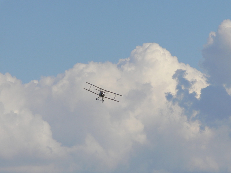 motion, transportation, cloud - sky, plane, sunlight, outdoors, silhouette, flying, no people, mode of transportation, airplane, mid-air, air vehicle, hunting machine