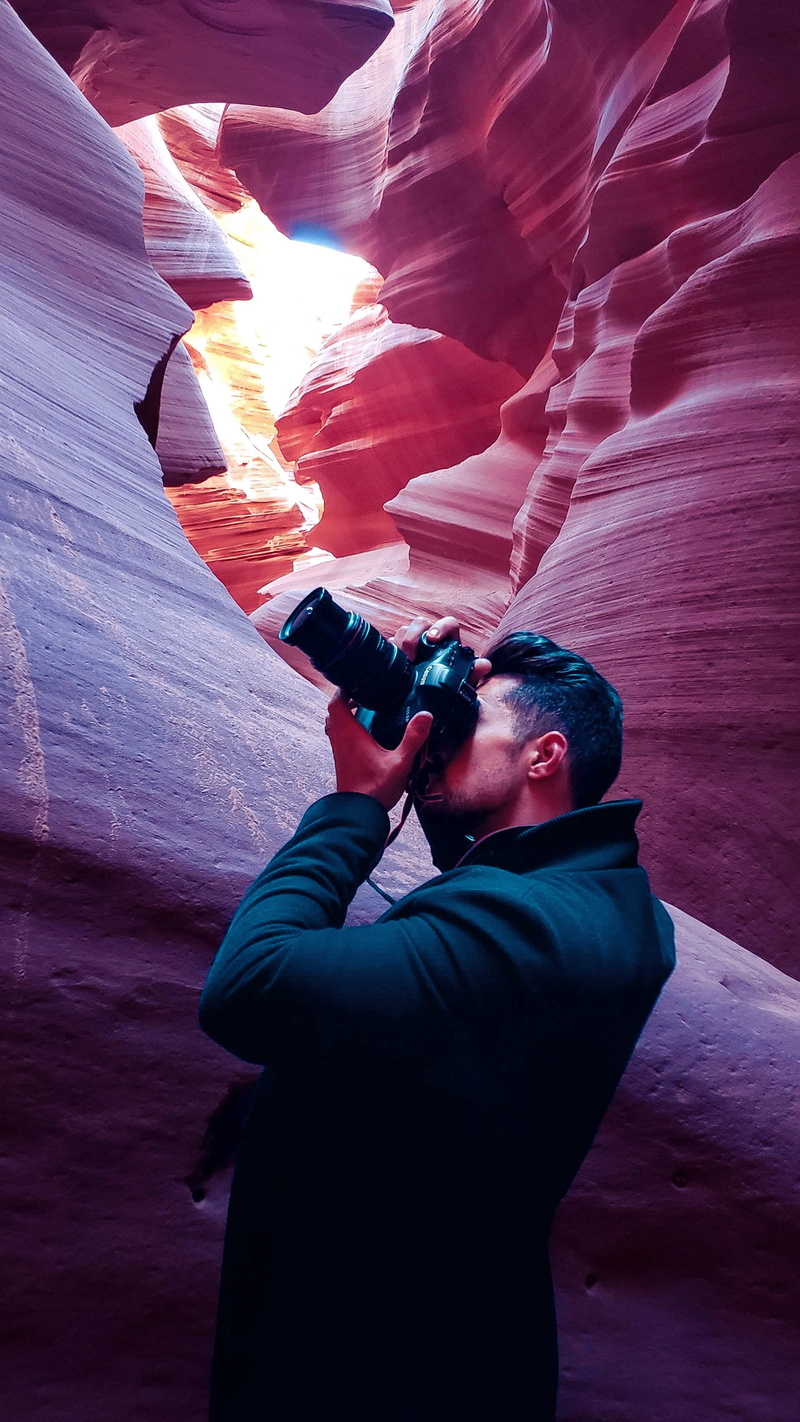 standing, lifestyles, rock formation, face, real people, portrait, camera - photographic equipment, canon, side pose, photography, photographing, rock - object