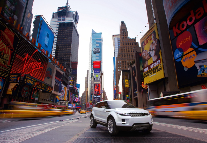 sign, street, car, taxi, 2K, evoque, city life, building, lrx, outdoors, on the move, suv, mode of transportation, white, concept, motion, city street
