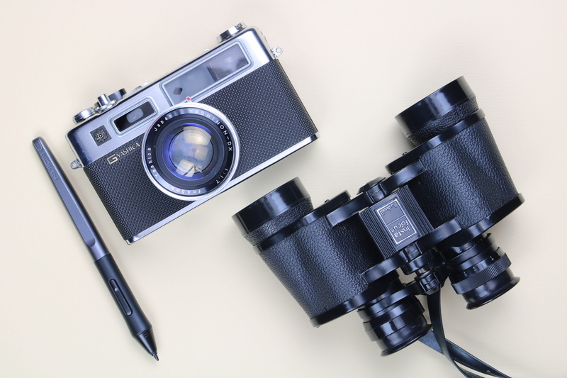 page, lens - optical instrument, money, raspberry, indoors, strap, logo, digital camera, still life, pen, technology, photographic equipment, symbol, trademark