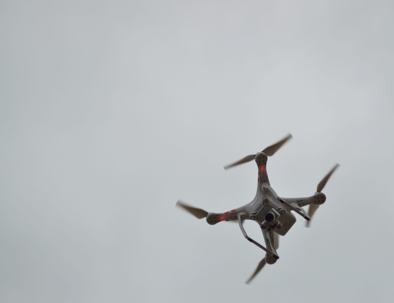 sky, gray background, motion, aggression, drone, air, air vehicle, camera, helicopter, vehicle, propellers, spy, lens, surveillance, side view, gray, technology
