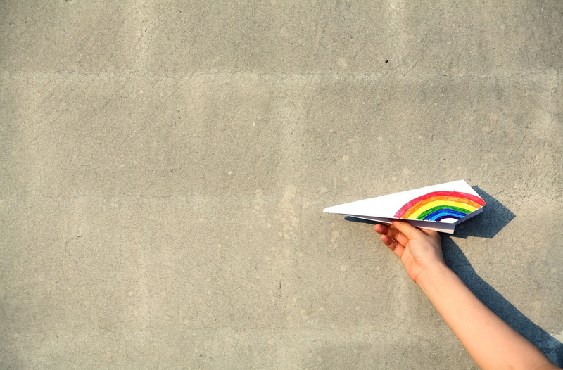backgrounds, full screen, book, people, boy, education, females, personal perspective, human limb, finger, girl, women, hand, paper airplane