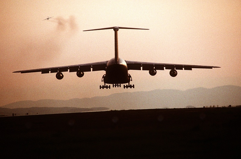 cargo, airport runway, motion, mode of transportation, landing - touching down, airplane, aircraft, commercial airplane, arrival, no people, aerospace industry