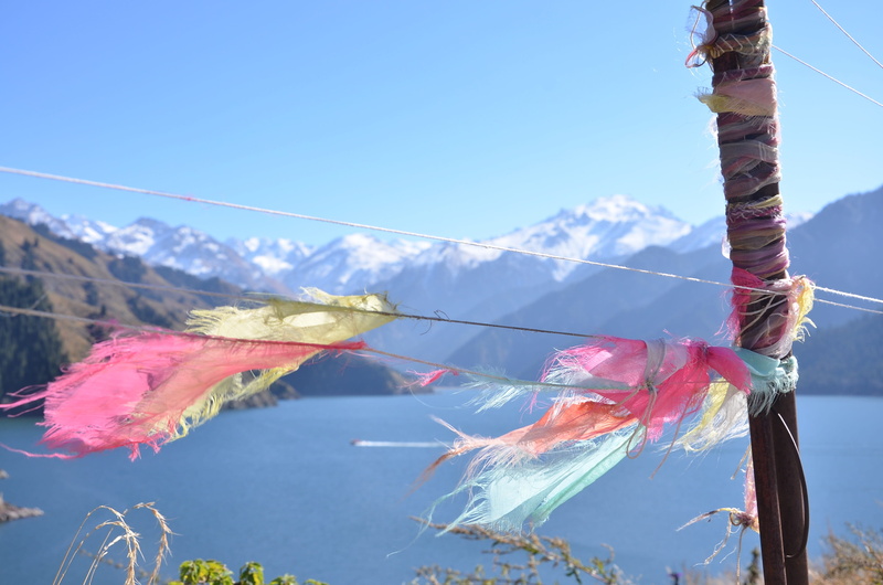 clear sky, plant, sunlight, mountain, focus on foreground, flag, outdoors, artistic conception, winter, ties, nature, low angle view, picture, tranquility