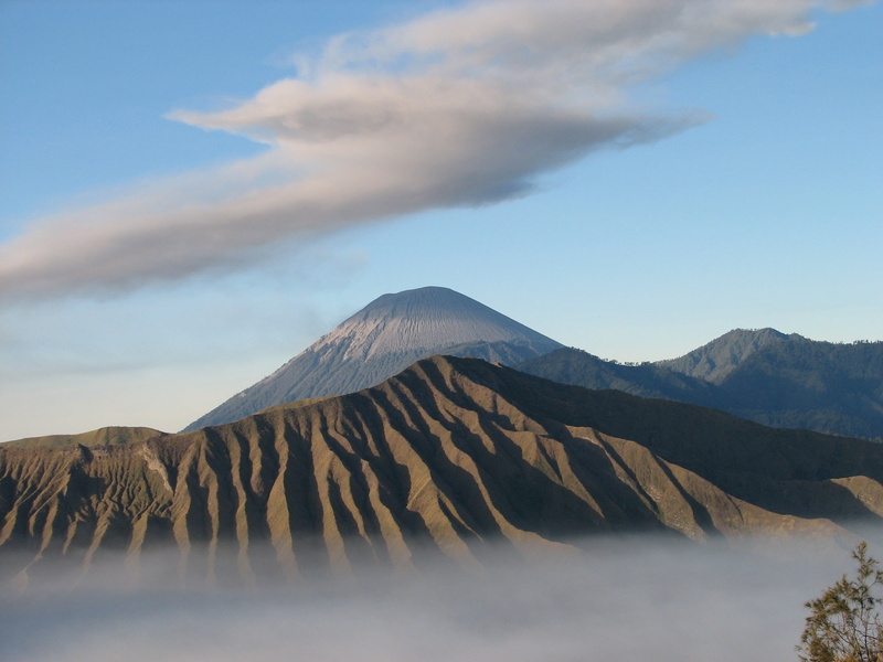 non-urban scene, smoke - physical structure, environment, bromo, geology, mountain, beauty in nature, scenics - nature, mountain range, cloud - sky, volcano