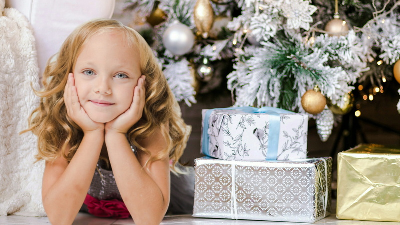 head in hands, decoration, fun, xmas, anticipation, innocence, blond hair, tree, girl, contemplation, females, indoors, dress, surprise, excited, young