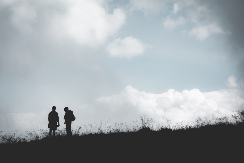 lifestyles, silhouette, people, beauty in nature, men, togetherness, scenics - nature, rear view, leisure activity, cloudy, two people, standing, day, hill