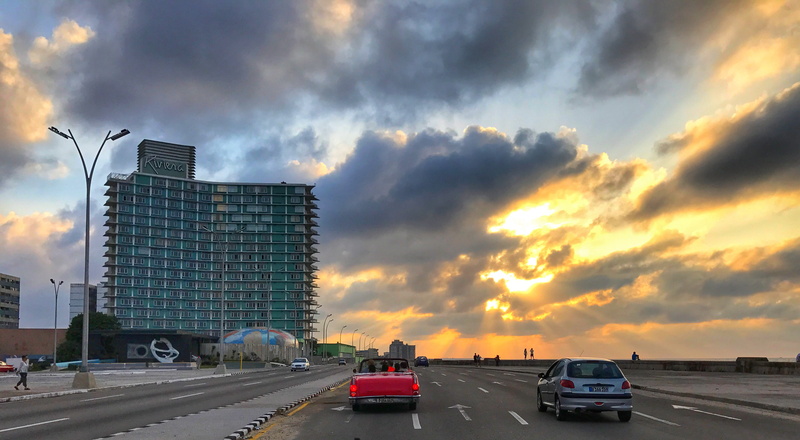 motor vehicle, malecón habanero, nature, 2K, building, multiple lane highway, skyscraper, sign, cloud - sky, office building exterior, road, sunset, mode of transportation