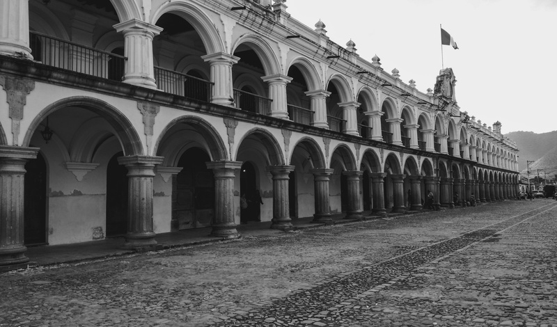 travel, sky, 2K, courtyard, outdoors, in a row, architectural column, day, old, flag, tourism, built structure, guatemala, colonnade, no people, colonial