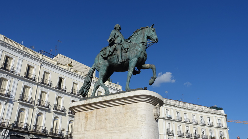 sky, outdoors, city, representation, blue, memorial, architecture, great, male likeness, puerta del sol, madrid, history, statue, no people, the past, of the sun door