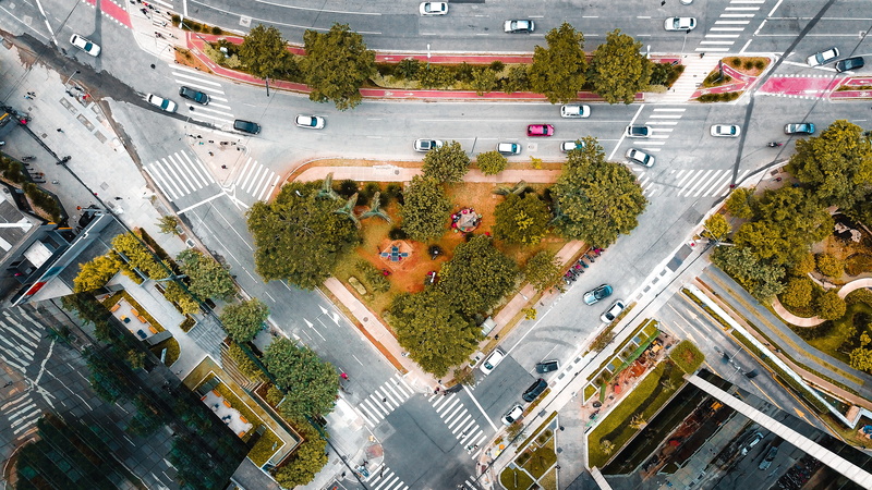 transportation, building exterior, crossroad, cityscape, yard, symbol, land vehicle, city life, city street, street, city, vehicle, campus, no people, angle