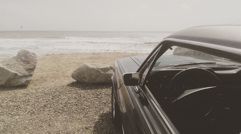 outdoors, car, sky, seaside, tranquility, motor vehicle, transportation, sand, beach, horizon over water, beauty in nature, ocean, mustang, land, scenics - nature