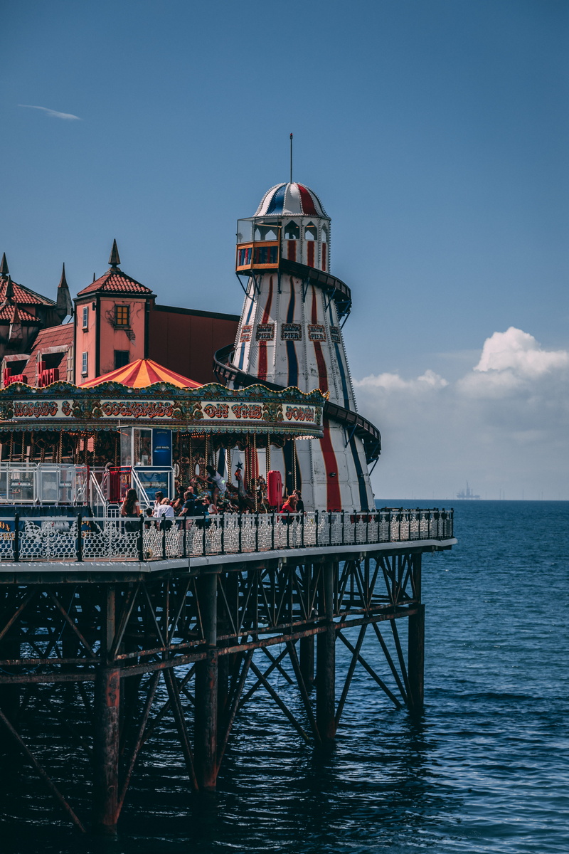 building, built structure, carnival, pier, people, amusement, near, park, transportation, travel, architecture, no people, sky, tower, building exterior