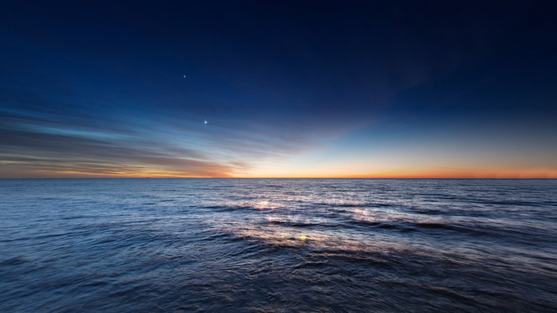 sea, astronomy, motion, nature, water, horizon over water, seascape, sunset, outdoors, space, beauty in nature, no people, tranquility, tranquil scene