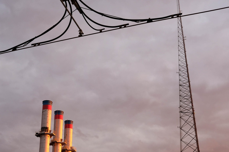 radio tower, environmental issues, built structure, outdoors, no people, day, architecture, factory, electricity, smokestacks, low angle view, smoke stack
