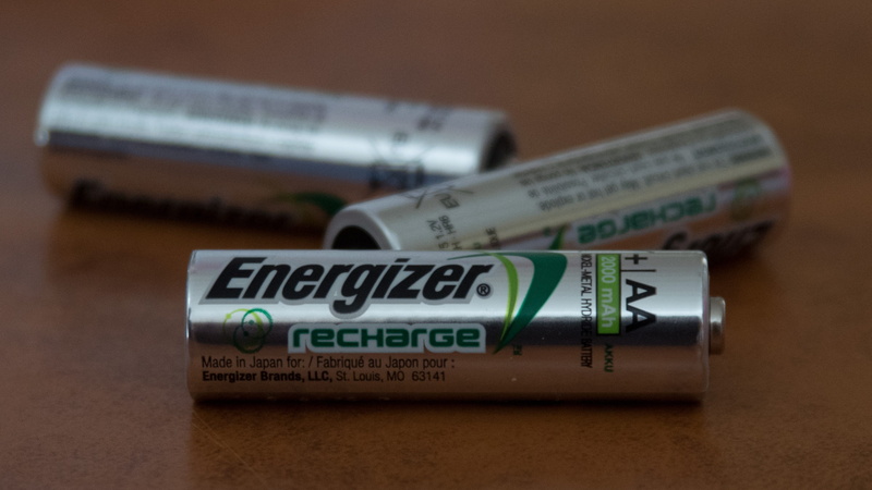 studio shot, 2K, source, western script, volts, sign, rechargeable, currency, communication, energizer, three, no people, indoors, single object, small group of objects