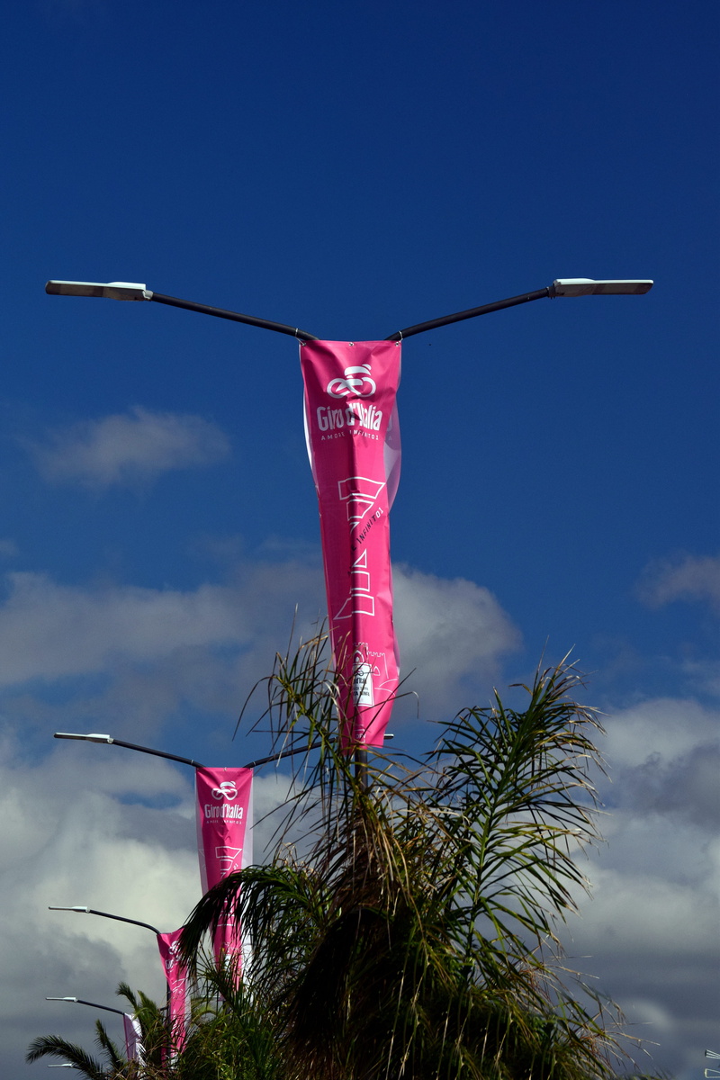 sicily, lamps, giro, flags, grass, no people, 5K, low angle view, clothesline, race, clouds, stage 5, outdoors, red, advertising, giro d italia, sky, plant