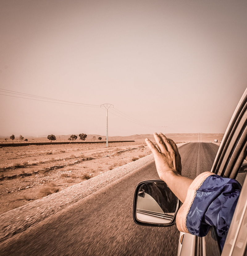 morocco, driver, human body part, one person, real people, driving, human foot, copy space, cable, low section, connection, human hand, wind, bmw, road